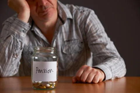 Depressed Man Looking At Empty Jar Labelled Pension Stock Photos