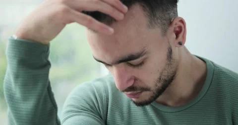 Depressed man looking out through window Stock Footage 156520816
