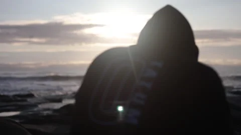 Depressed man sits before sunset Stock Footage 196268124