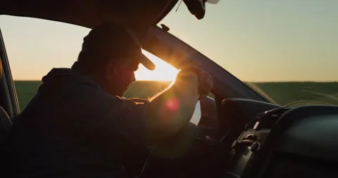 Depressed man sitting behind the wheel of a car Stock Footage 251363979