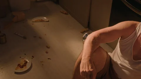 Depressed Man Sitting on Messy Floor Suffering from Alcoholism Stock Footage 344860818
