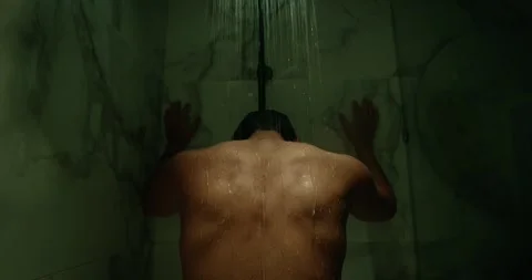 Depressed man suffer inner struggle. Sad person stand hot water stream shower. Vídeo Stock 338009416