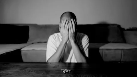 Depressed man suffering suicidal depression want to commit suicide by overdose Stock Footage 111361338