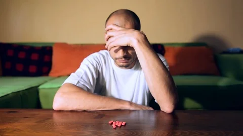 Depressed man suicidal depression commit suicide strong medicament drugs pills Stock Footage 111144691