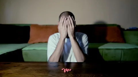 Depressed man suicidal depression commit suicide strong medicament drugs pills Stock Footage 111144713