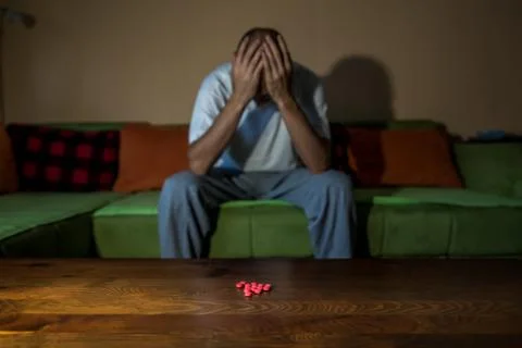 Depressed man suicidal depression commit suicide strong medicament drugs pills Stock Photos