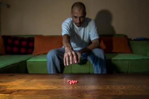 Depressed man suicidal depression commit suicide strong medicament drugs pills Stock Photos