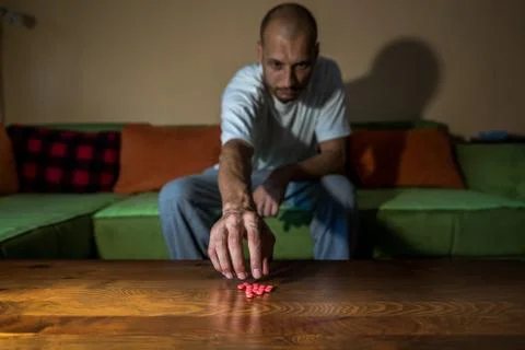 Depressed man suicidal depression commit suicide strong medicament drugs pills Stock Photos