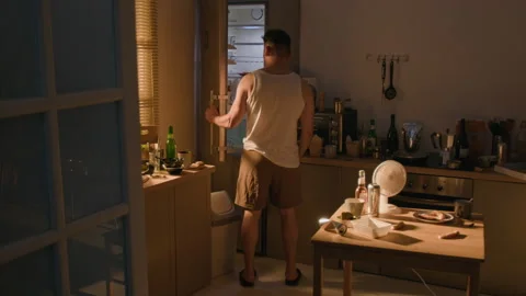 Depressed Man Taking Bottle of Alcohol from Refrigerator at Night Stock Footage 344870835