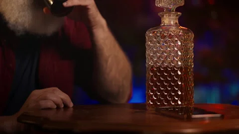 Depressed middle-aged man copes with holiday stress by drinking at home Stock Footage 346714219