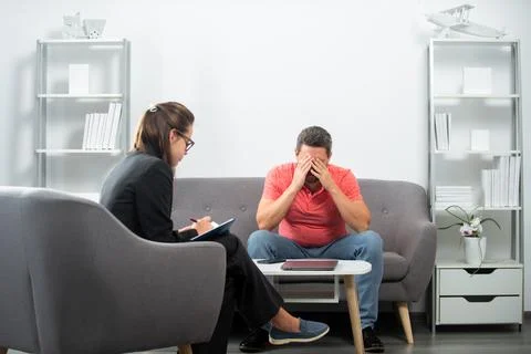 Depressed middle aged man problem therapy. Man discussing his psychological Stock Photos