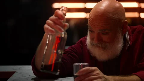 Depressed middle-aged man suffers from stress and drinks liquor alone Stock Footage 346714229