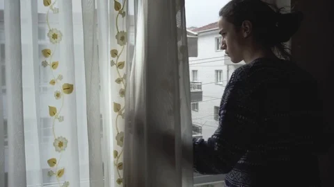 Depressed millennial guy watching the empty streets from his window Stock Footage 127335472