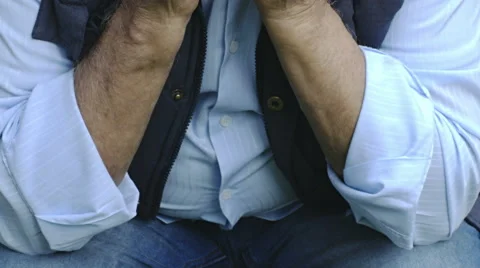 Depressed old man sitting alone and pensive outdoor in the garden  Video stock 68762055