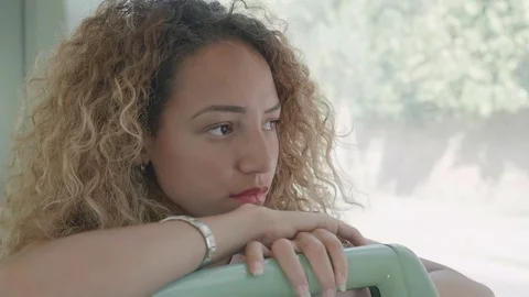 Depressed sad woman sitting alone and pensive on the bus in the town Stock Footage