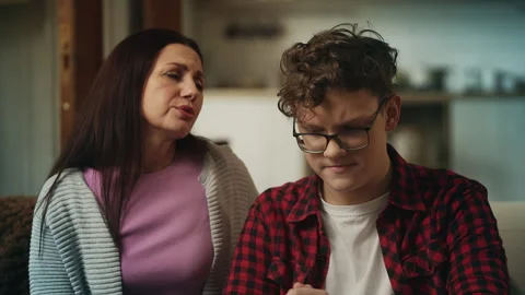 Depressed teen discussing school problems with his mother, receiving support Stock Footage 340254874