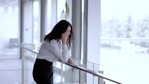 Depressed Woman Having Headache At Her Job And Holding Head Stock Footage 76326341