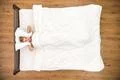 The depressed woman lay on the bed. View from above Photo