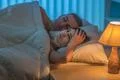 The depressed woman lie with man on the bed. Evening night time Photo