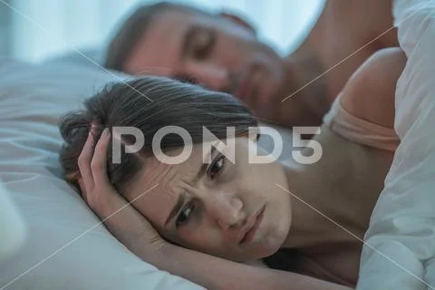 The depressed woman lie near the man Stock Photos