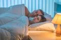 The depressed woman lie near the man. Evening night time Photo