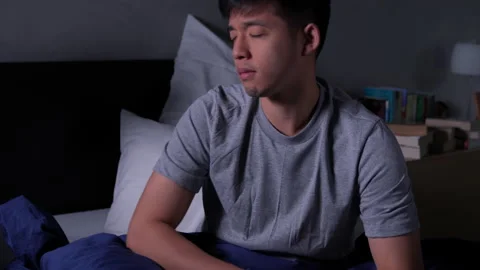 Depressed young Asian man cannot sleep from insomnia. 動画素材 140896807
