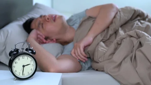 Depressed young Asian man cannot sleep from insomnia Stockbeeldmateriaal 156638115