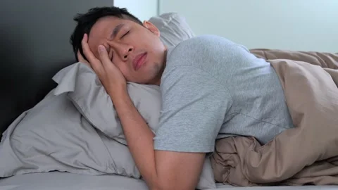 Depressed young Asian man cannot sleep from insomnia Video stock 156638247