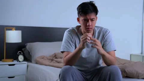 Depressed young Asian man cannot sleep from insomnia Video stock 156638375