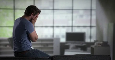 Depressed young man on a couch Video stock 78602925