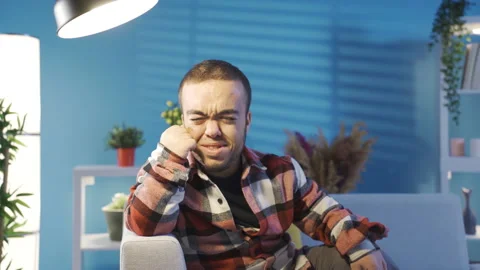 Depressed young man with dwarfism crying at home alone.  Stock Footage 230970910