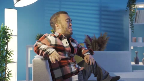 Depressed young man with dwarfism feeling unwell, crying and feeling sad. Stock Footage 230970862