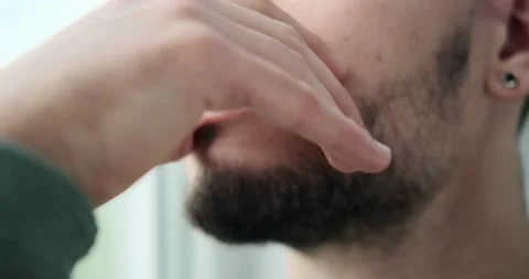 Depressed young man looking out through window Video stock 156469742