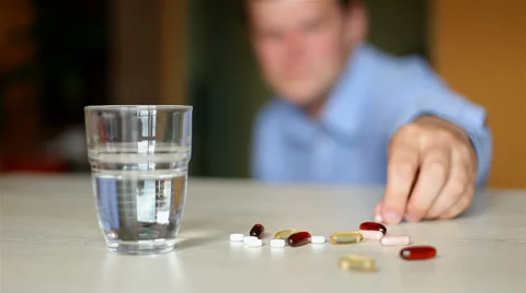 Depressed young man. taking a pill. Stock Footage 25220787