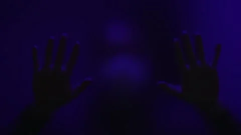 Depression concept. silhouette of man behind glass door. hands are placed on Stock Footage 253584514