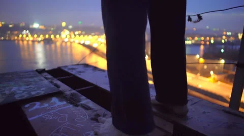 Depression, lonely barefoot male standing on top of bridge, suicidal thoughts Stock Footage