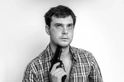 Depressive man trying to commit suicide with a gun aiming on his head Foto stock