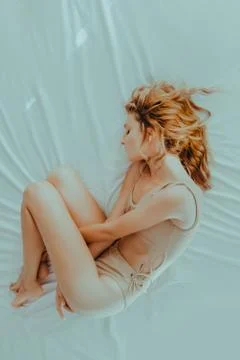 Depressive redhead model laying on bed Stock Photos