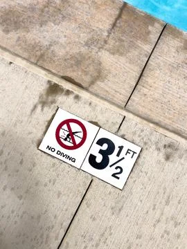 Depth Marking on Poolside Concrete Stock Photos