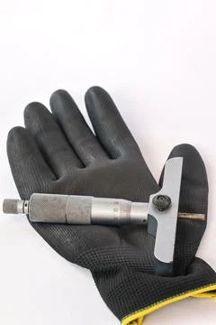 Depth micrometer on black work glove background. Photos