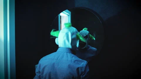 Deranged killer clown looks at himself in a bathroom mirror Stock Footage 233084972