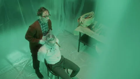 Deranged Killer Suffocating Victim with Plastic Bag in Gloomy Torture Room Video stock 301506630