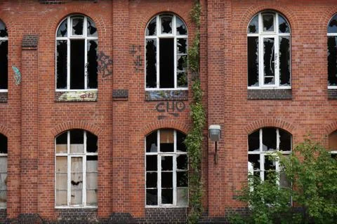 Derelict facade with broken windows Stock Photos
