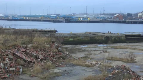 Derelict old ship yard littered with red bricks river in background 動画素材 1090463