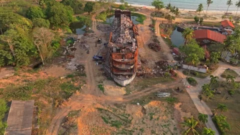 Derelict ship stands still in sunset waters near island, Thailand Stock Footage 310053364