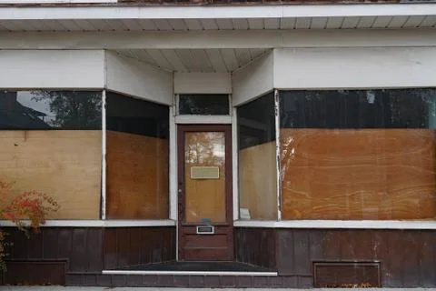 Derelict storefront with boarded up windows Stock Photos