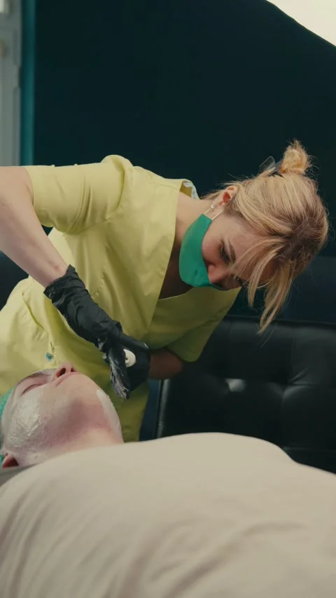 The dermatologist performs a cleansing procedure on the patient's problem skin Stock Footage 285496926