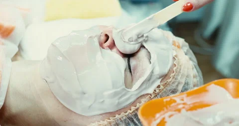 A dermatologist performs a procedure to cleanse the skin of the face. The Stock Footage 167966085
