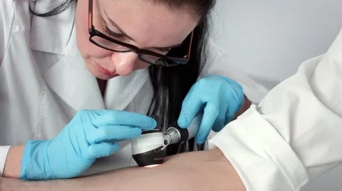 Dermatologist view skin through dermatoscope Stock Footage 61110936