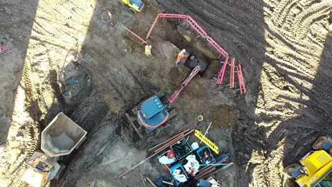 Descending aerial view of a digger digging new drainage trenches Stock Footage 340535982